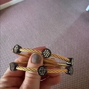 Yellow metal braided bracelets with alternating black circular charms